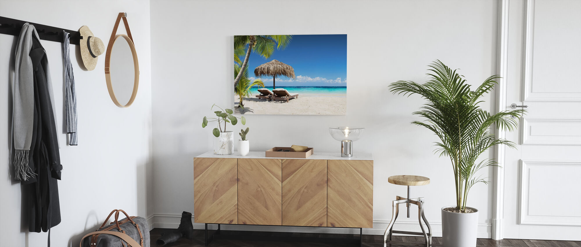 canvas prints from photowall entryway room with coat hanger on wall and coat hat scarf buffet with canvas picture of two beach chairs and scene above it potted palm plant