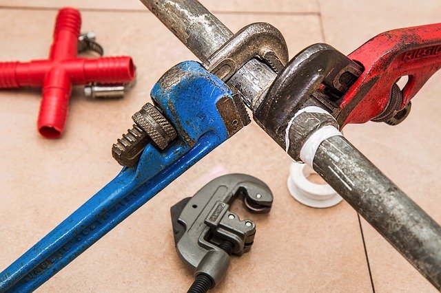 turn property into rental wrenches fixing plumbing pipes