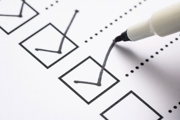 pen checking off a box on a paper checklist