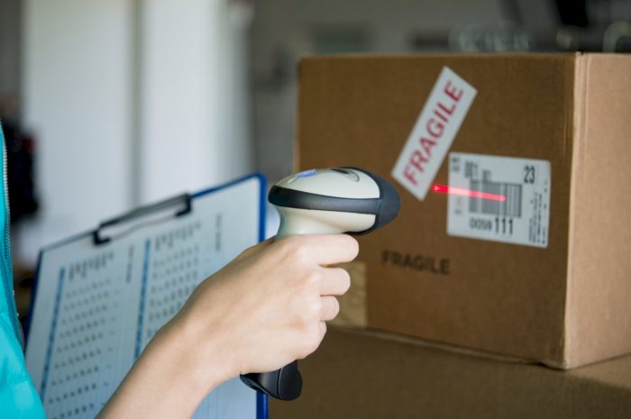 person scanning package doing delivery services for business