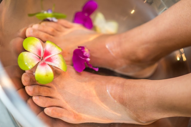 taking care of toes soaking them in water with flowers