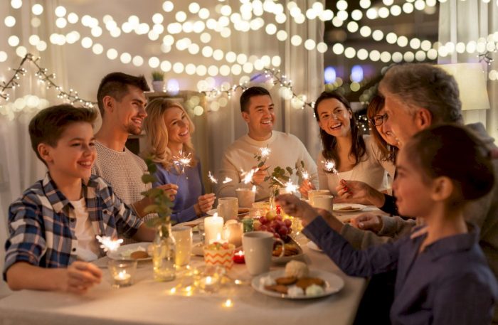 financial stability big families large family eating in a tent outside with sparklers and lights