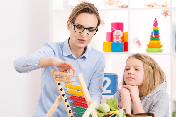 siblings busy homeschool mom and daughter using an abacus for homeschool math teaching