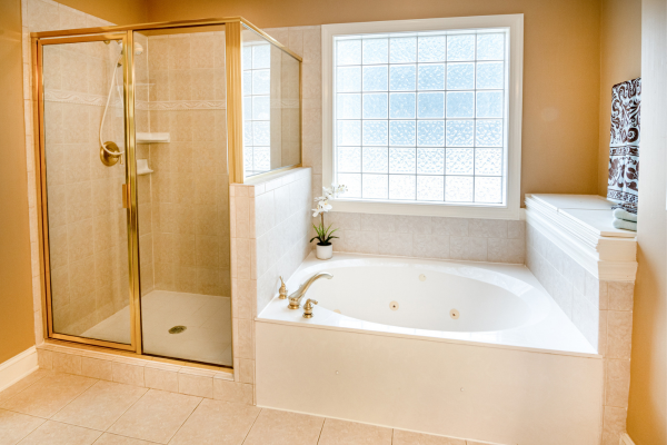 transform your bathroom gold coated metal glass shower door to walk in shower next to oval bathtub with water jets under window