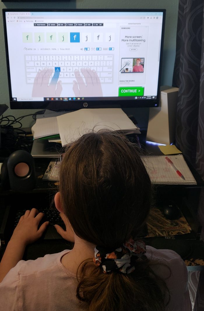 girl working on letter typing practice with letters f and j typedojo
