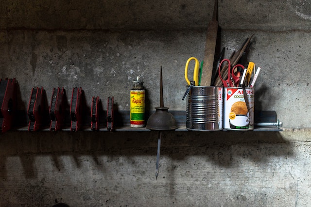 organized shelf of tools and various things after decluttering the garage