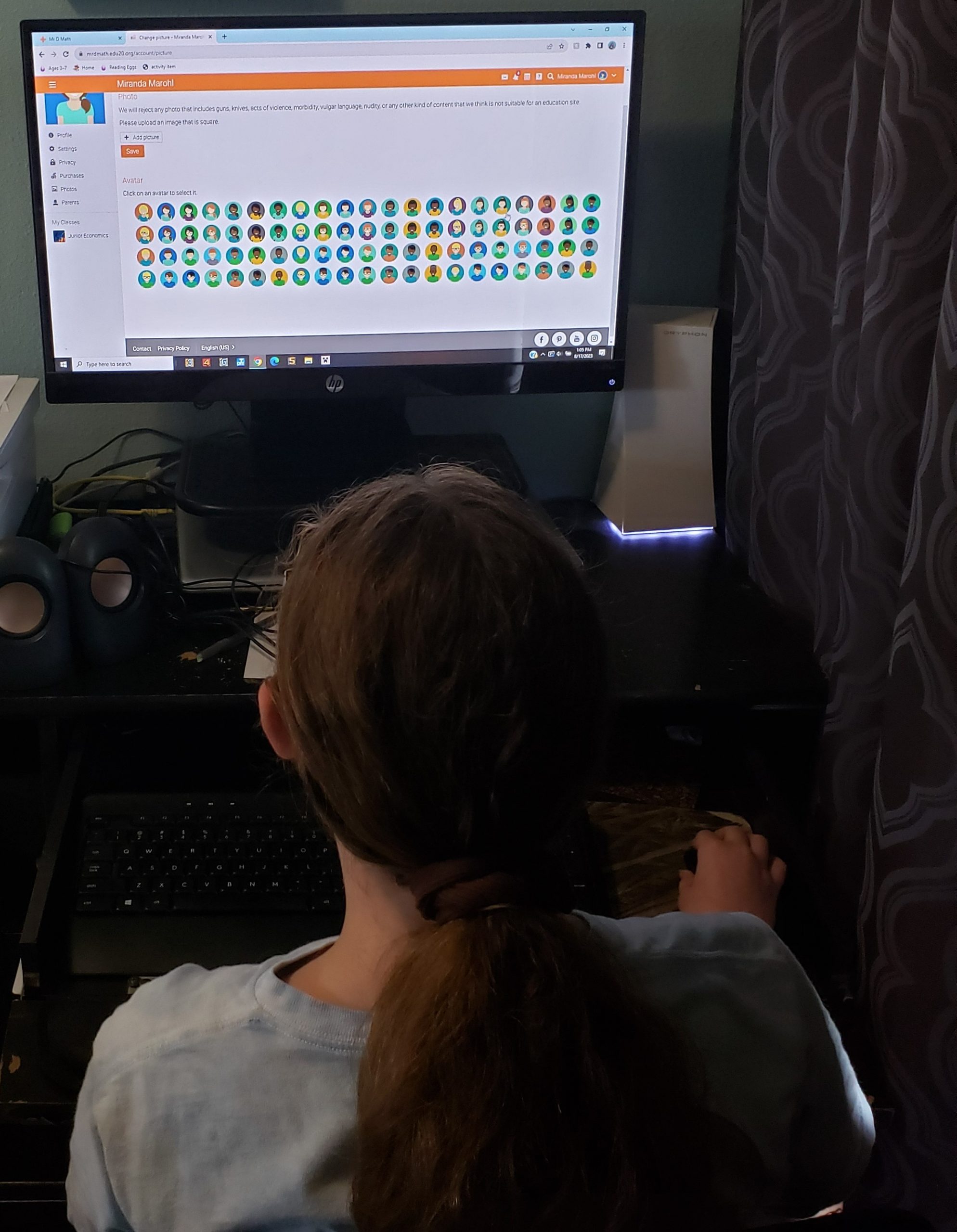 girl is choosing her avatar hair skin shirt color on computer monitor