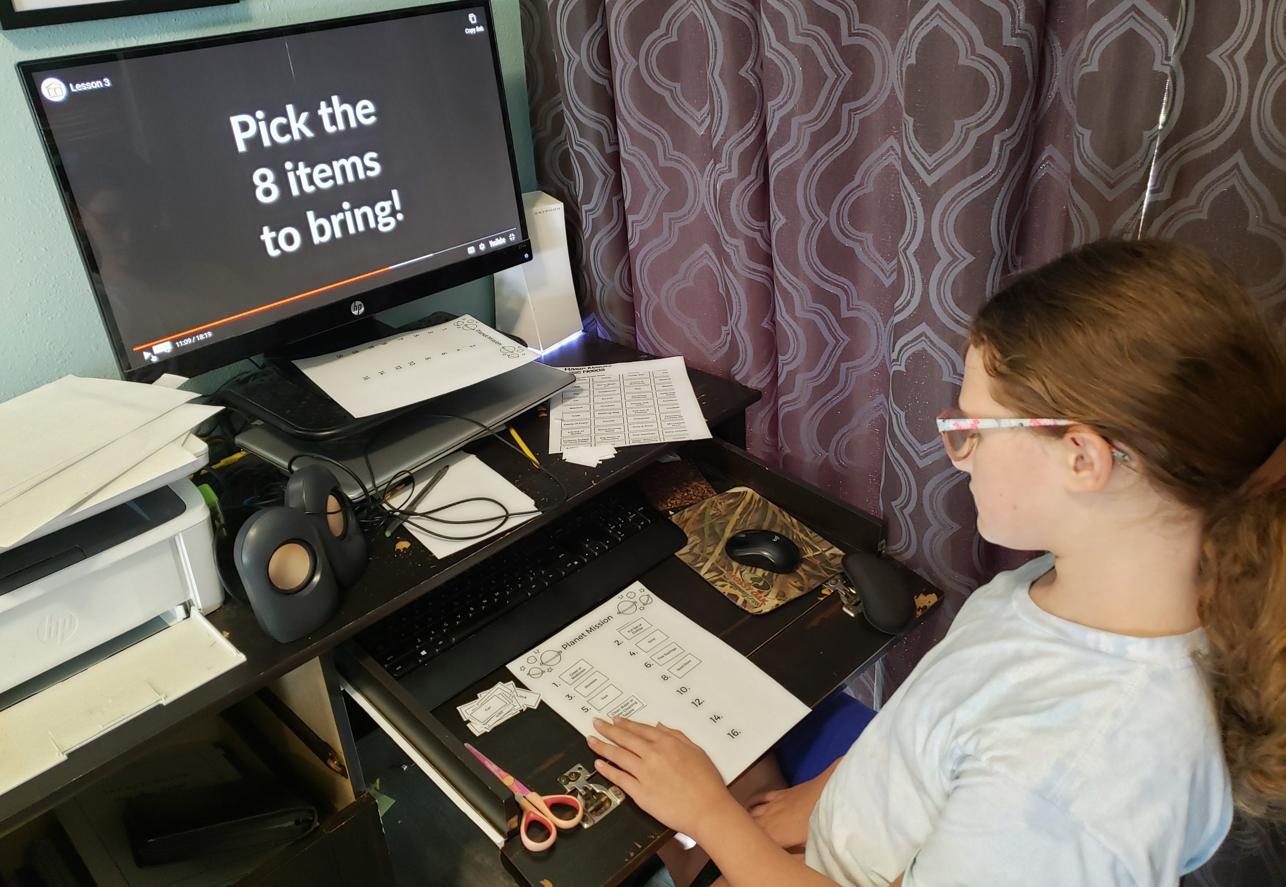 computer desk monitor says pick the 8 items to bring and girl is placing each item on a numbered list