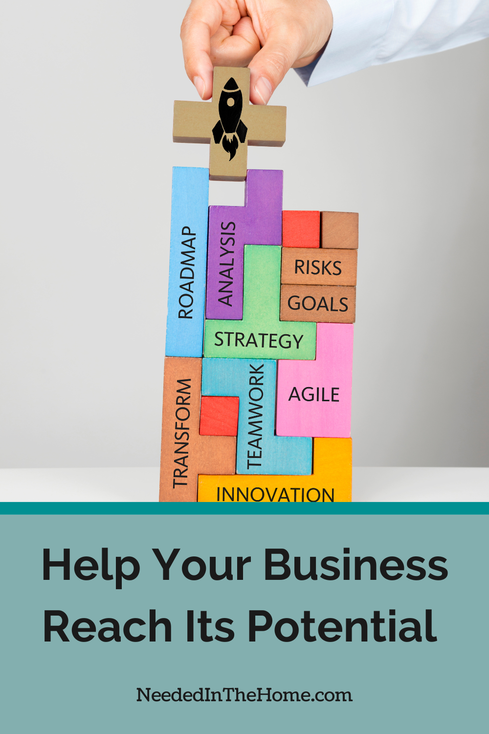 hand stacking colorful blocks with rocket image and words roadmap analysis risks goals strategy transform teamwork agile innovation help your business reach its potential neededinthehome