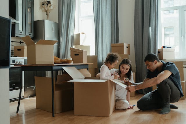 family with boxes around them preparing for a house move