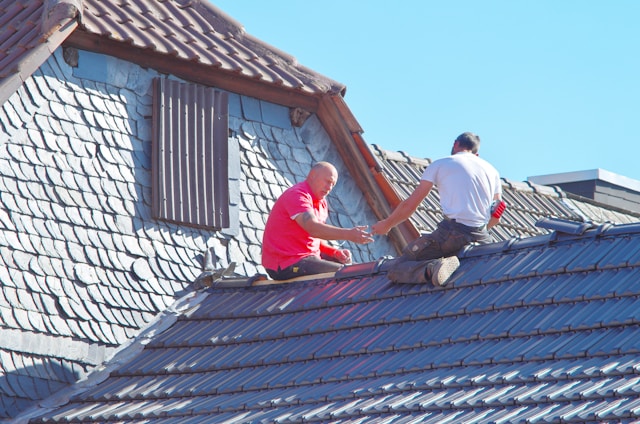 two men on roof doing repairs