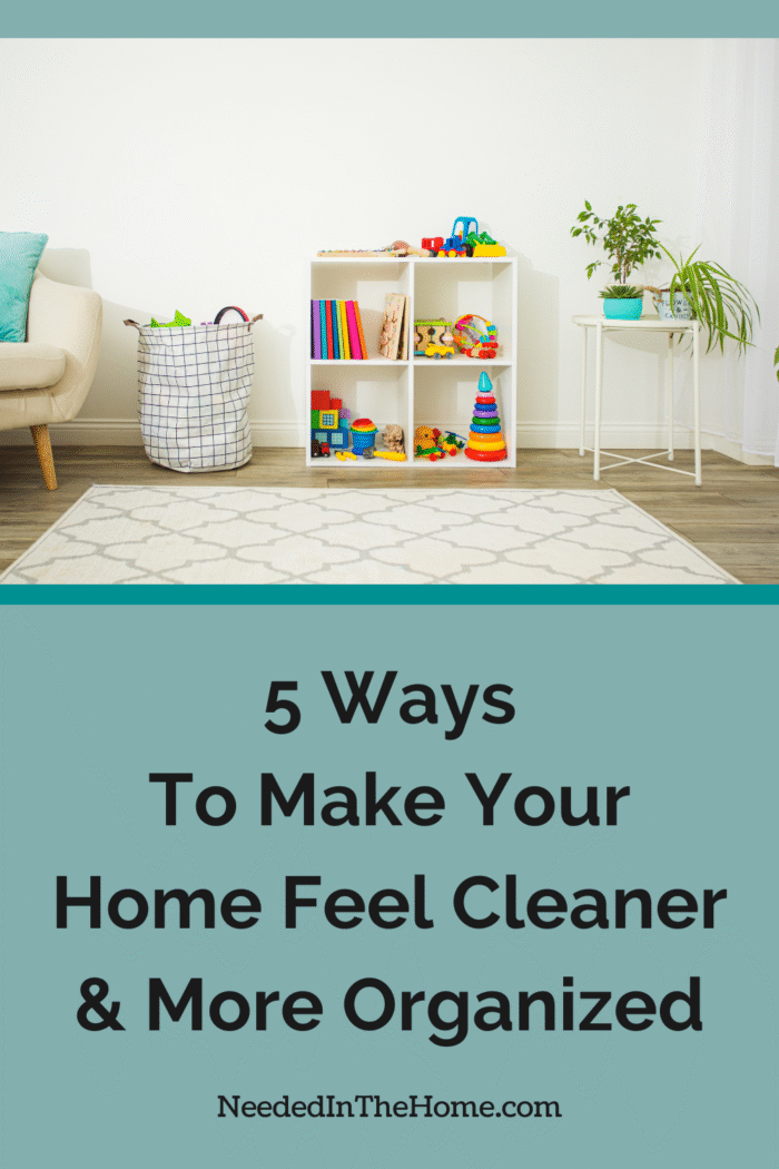 With the right strategy at your disposal, your home will feel cleaner. Here are five of the best ways to regain control. toy section of living room all cleaned up with toys on shelf and in a large fabric bag 5 ways to make your home feel cleaner and more organized neededinthehome