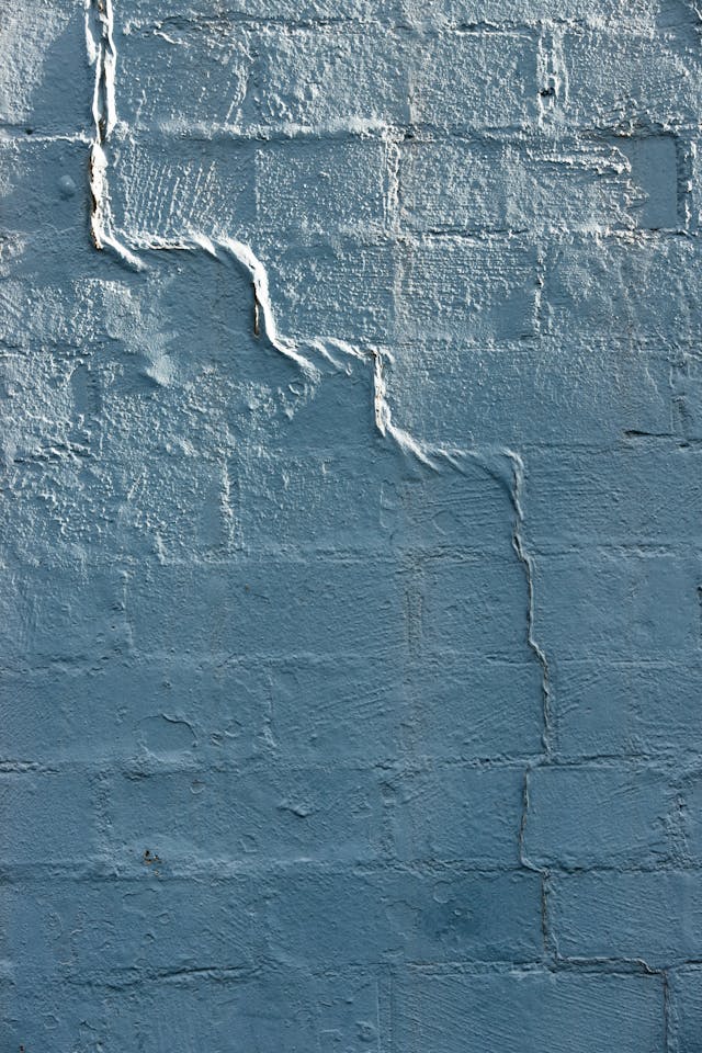 brick wall from basement foundation with repaired and caulked area