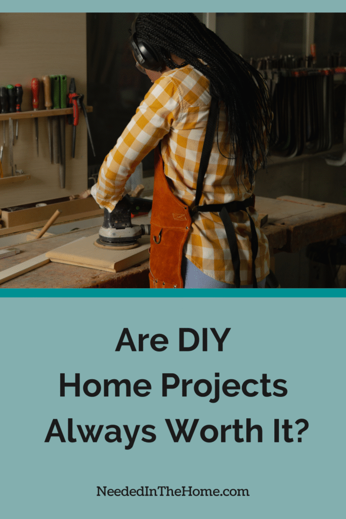 woman at work bench sanding a piece of wood are diy home projects always worth it neededinthehome
