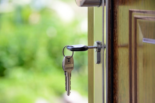 keys in lock of front door to house