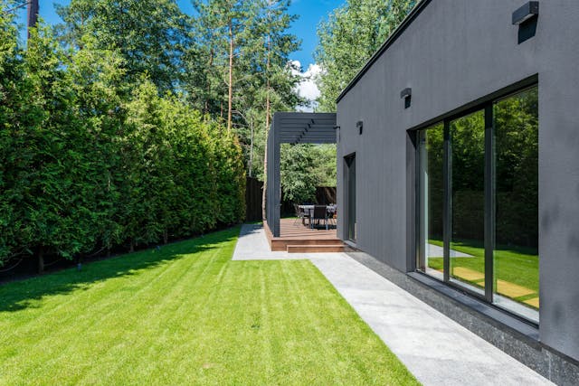 When you are unhappy with your lawn, a dramatic change is required - and that might even be easier to do than you think. backyard of house with deck patio lawn walkway and hedges