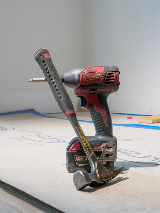 When we design a living space, we often put priority on the way it looks. Yes, your home looks good, but is it functioning well? cordless drill and hammer sitting in a room that is being remodeled
