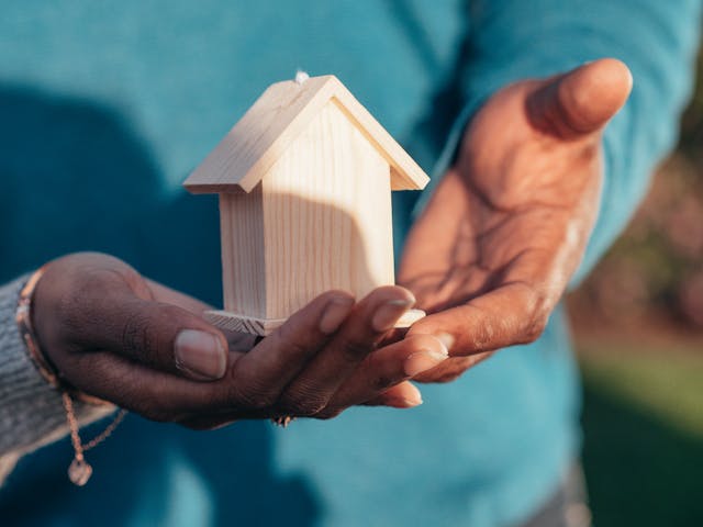 Is it time to update your home? If you enter your home every day, feeling as though you wish it were different, then it’s time for change. persons hands holding a small wodden house