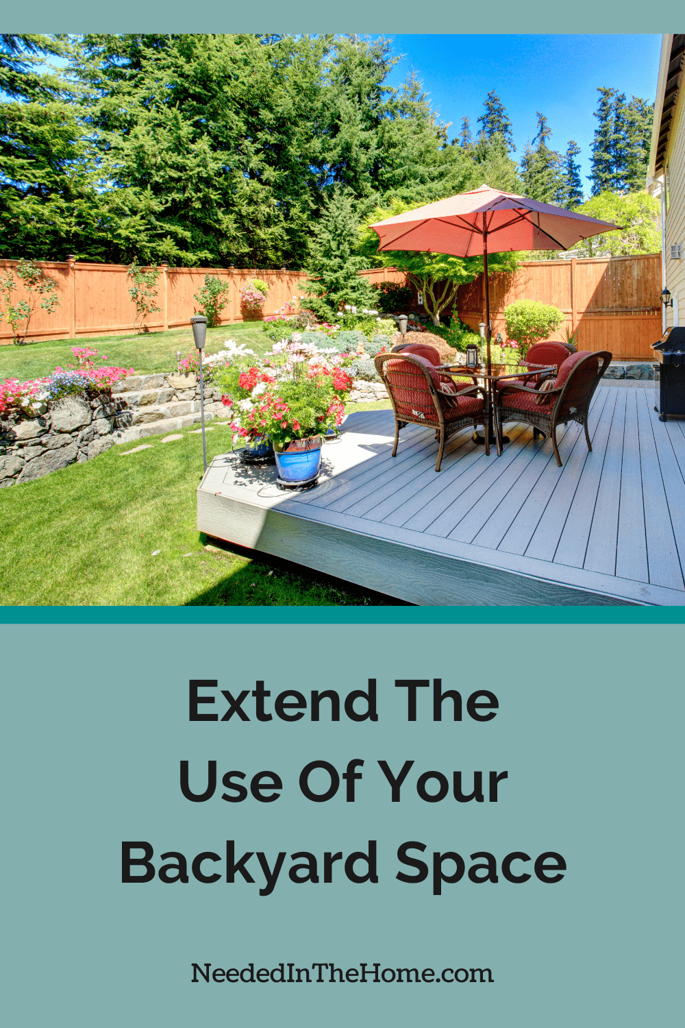 fenced in backyard with rock wall and stone steps wooden deck with table chairs umbrella potted plants grill lighting extend the use of your backyard space neededinthehome