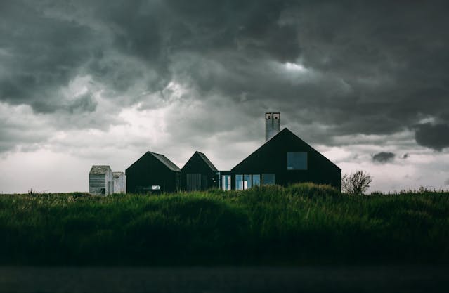 dark cloudy sky over house on prairie