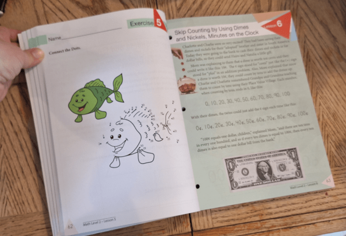 open spread of math workbook pages in master books math lessons for a living education workbook with a fish dot to dot and learning about money with a dollar bill pictured on the page
