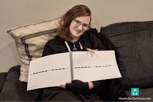 teen girl holding open a blank timeline for history learning