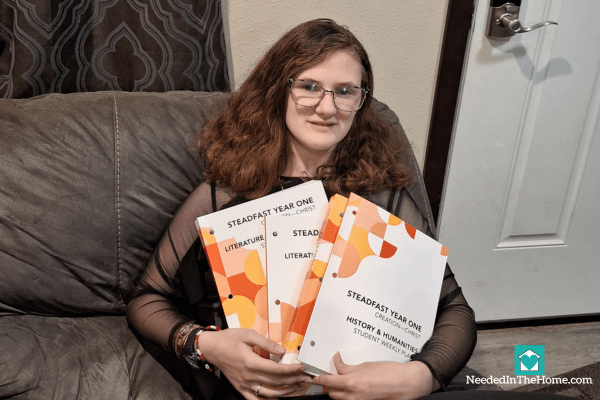 teen girl holding several books from steadfast press