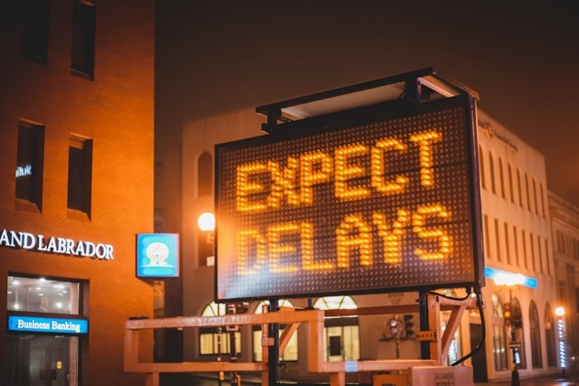 lit up sign that says expect delays