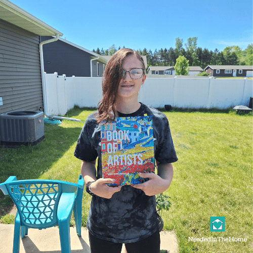 teen girl holding an artist book