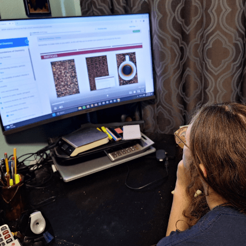 This is our product review of the Axiom Science High School Chemistry online course with 191 videos, 50 self-grading quizzes, and 20 Labs. teen girl wearing glasses learning chemistry on computer screen with axiom chemistry course