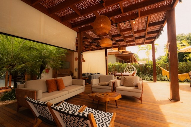 When you expand your living space with home renovation ideas beyond the walls, into the yard, you're creating your own little haven. outdoor patio with awning, wood flooring, furniture