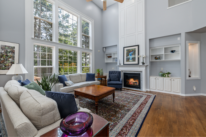 living room with large windows fireplace area rug built ins