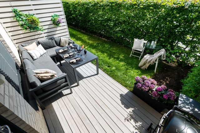 tiny backyard space made functional with outdoor furniture and backyard plants