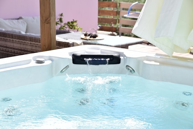 hot tub with water coming out in a small waterfall into the water