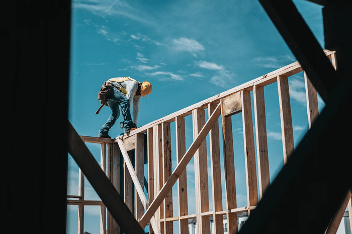 When you do research to find home contractors, it can expose you to persistent sales calls, online tracking and poorly secured quote forms. man in hardhat standing on house frame